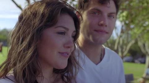 Closeup Of Cute Couple Sitting On A Bench Together On A Beautiful Summer Day Stock Footage 54927361