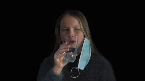 Closeup of a Cute Sick  Girl ingesting a pill and drinking it with a water Stock Footage 125013707