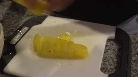 Closeup cutting pineapple into pieces with a knife Stock Footage 193002987