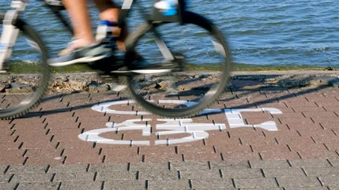 Closeup on cycling path sign with moving bicycle Stock Footage 166799954