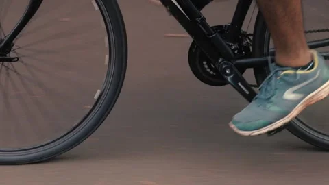 Closeup of cyclist pedaling on a road Stock Footage 165445361