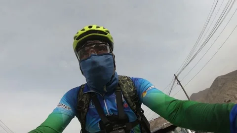 Closeup of a cyclist riding his bicycle along the avenue La Molina Stock Footage 144271353
