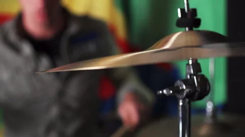 Closeup of cymbals while man plays drums in the background Stock Footage 50204769