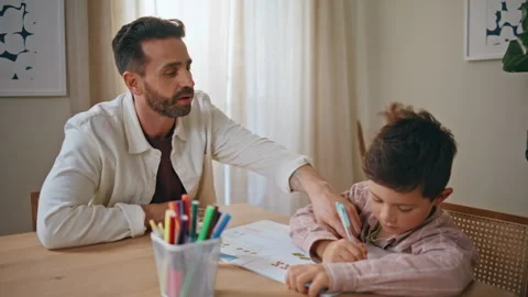 Closeup dad teaching boy doing homework in living room. Small child and parent Video stock 278167519