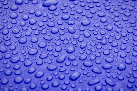 Closeup of dark blue surface with dense water droplets forming textured con.. Stock Photos