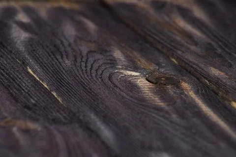 Closeup of a dark board texture. Macro brushed wood. Stock Photos
