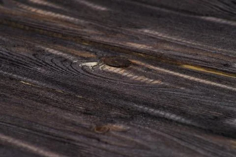Closeup of a dark board texture. Macro brushed wood. Stock Photos