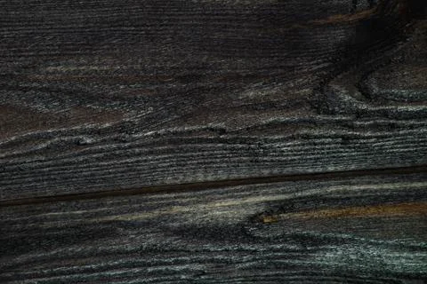 Closeup of a dark board texture. Macro brushed wood. Stock Photos