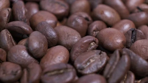 Closeup of dark roasted coffee beans on rotating table. Stock Footage 140089083