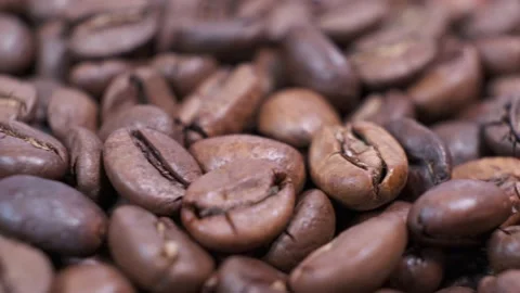 Closeup of dark roasted coffee beans on rotating table. Stock Footage 140089811