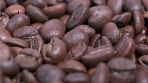 Closeup of dark roasted coffee beans on rotating table. Stock Footage 140353207