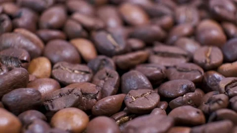 Closeup of dark roasted coffee beans on rotating table. Stock Footage 140675976