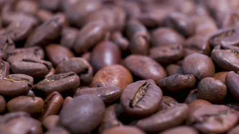 Closeup of dark roasted coffee beans on rotating table. Stock Footage 140704682