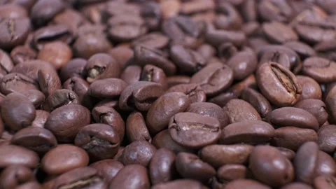 Closeup of dark roasted coffee beans on rotating table. Aromatic coffee grains Stock Footage 140905714