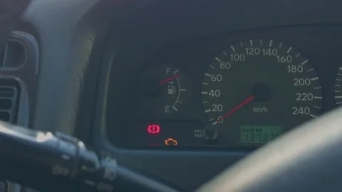 Closeup dashboard engine light illuminated, technician inspecting instrument Stock Footage 333260530