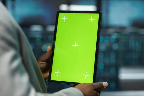 Closeup of data center engineer using green screen tablet, managing rackmounts Stock Photos