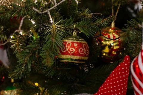 A closeup of a decorated Christmas tree with red and gold ornaments Stock Photos