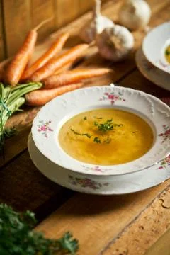 Closeup of delicious home made broth on old wooden table Stock Photos