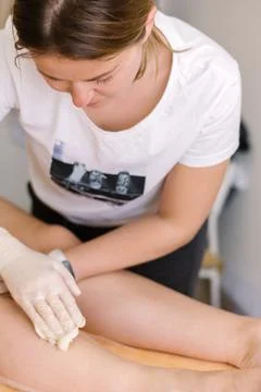 Closeup depilation process using pink sugar pasta of female body parts in a Stock Photos