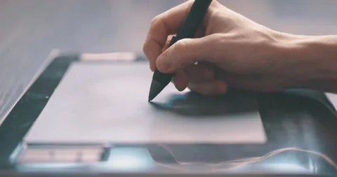 Closeup of designer drawing using a graphics tablet and stylus pen Stock Footage 149078134