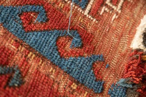 Closeup detail of border pattern threadbare carpet restoration Stock Photos