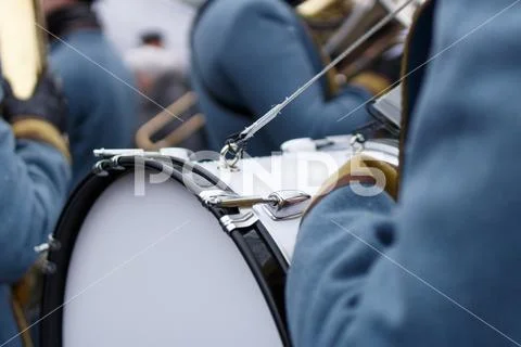 Closeup detail of retro weared standing back soldier drummer with big drum and Stock Photos