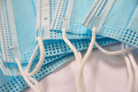 A closeup detail shot of a stack of single use medical face masks Stock-Fotos