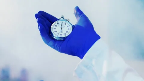 Closeup details scientist hands with protective blue gloves holding a manual Stock Footage 153086584