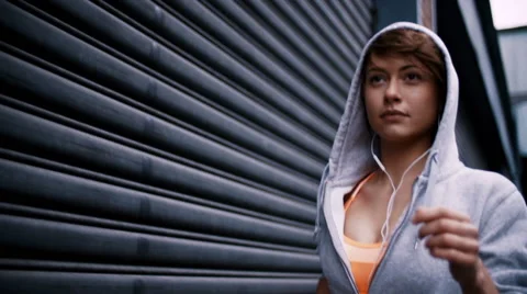 Closeup of determined woman runner running in slow motion Stock Footage