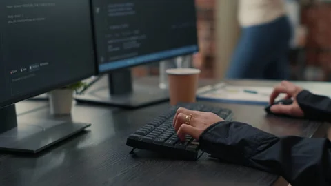 Closeup of developer hands typing code on keyboard while looking at computer Stock Footage 168233088