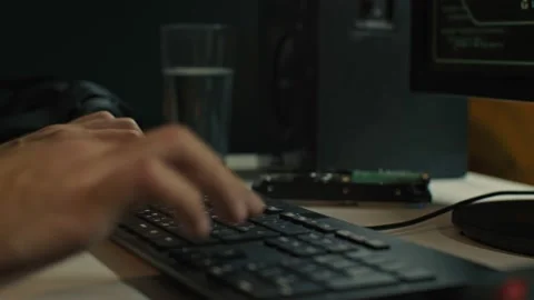 Closeup of developer hands typing code on keyboard while looking at computer Stock Footage 169107630