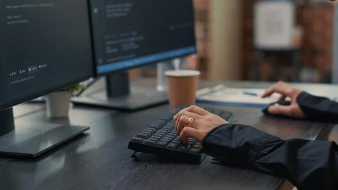 Closeup of developer hands typing code on keyboard while looking at compute.. Fotos de archivo