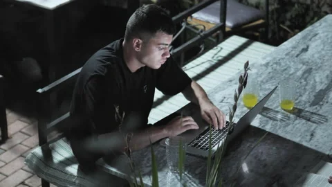 Closeup of devloper man hands typing, coding on a laptop while on in a beach  Stock Footage 155192130