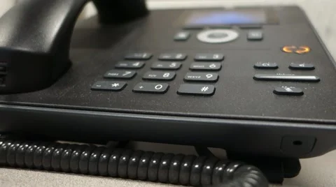 Closeup dialing an office desk phone Stock Footage 50489631