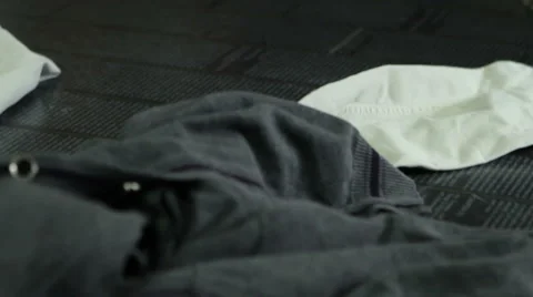 Closeup of different multicolor clothes, tissue falling into the magazine. Stock Footage 45792842