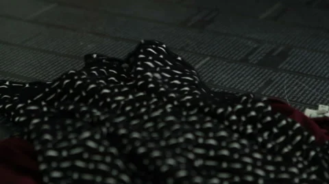 Closeup of different multicolor clothes, tissue falling into the magazine. Stock Footage 45792947