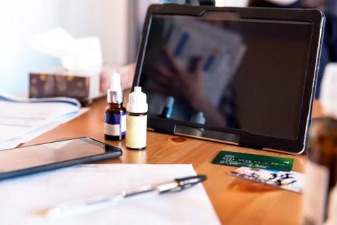 Closeup digital tablet on table at home with mdeicines next to it Photos