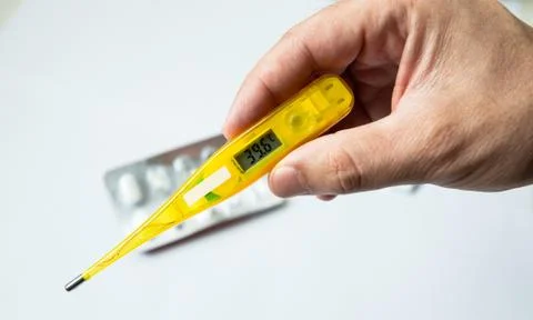 Closeup of Digital thermometer in the hand Stock Photos