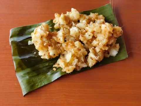 Closeup of a dish (tapioca curry) served on a banana leaf placed on the woode Stock Photos