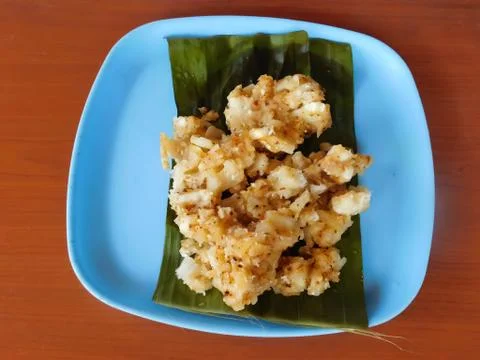 Closeup of a dish (tapioca curry) served on a bowl placed on the wooden surfa Stock Photos