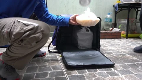 Closeup disinfecting with bleach a blue backpack with bagged food delivery on 库存影片 156439537
