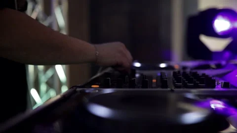 Closeup of dj hands with light effects. Side view Video stock 157307916