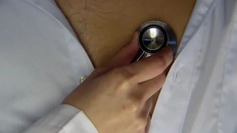 Closeup of doctor hand using stethoscope on patient's chest Stock Footage 146427855