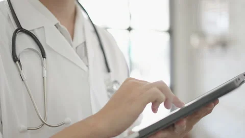 Closeup Doctor typing Research analysis job working with tablet pc Stock Footage 170054792