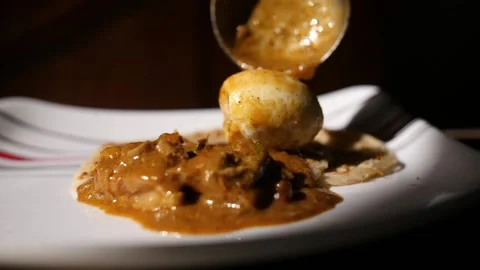 Closeup dolly out slow motion shot of parotta and chicken curry on a plate Stock Footage 131287858