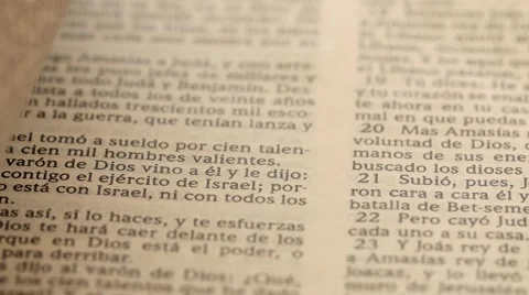 A closeup dolly shot of man closing the bible santa biblia Stock Footage 60693392