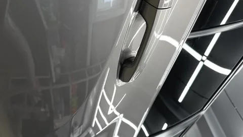 Closeup of door handle of Grey mirror premium car in the detaling studio after Stock Footage 243628626