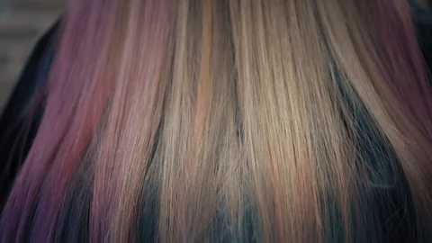 Closeup down-up view on dyed pink and blonde woman's hair in hair salon. Back Stock Footage 86711386