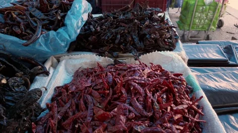 Closeup of Dried Red and Dark Chili Peppers Displayed at Traditional Market Stock Footage 342236101