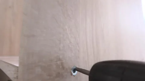 Closeup Of Drill Attaching Screw Into Particle Board For Furniture Construction Stock Footage 329107024